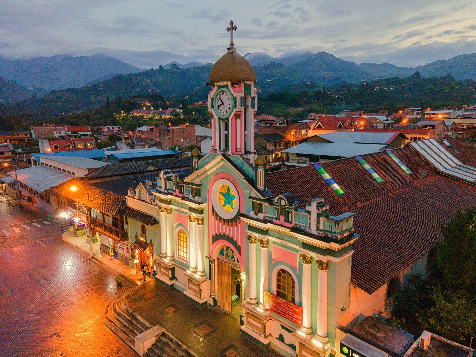 Illuminated colonial church at dusk in a mountain town, Ecuador