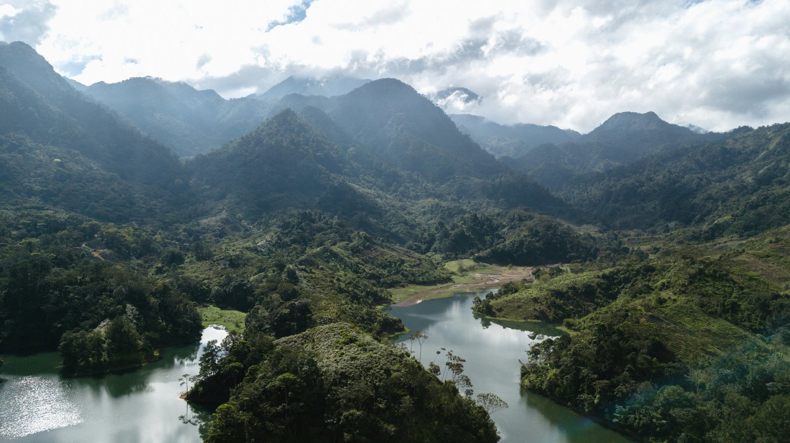 Aerial view of lush mountain valleys and winding rivers in the Honduran highlands